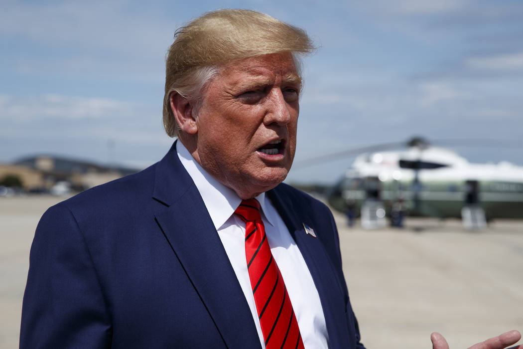 President Donald Trump talks with reporters after arriving at Andrews Air Force Base, Thursday, ...