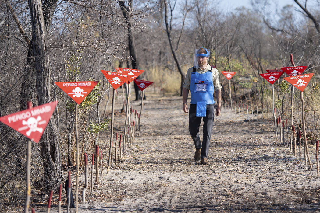 Britain's Prince Harry walks through a minefield in Dirico, Angola, Friday Sept. 27, 2019, duri ...