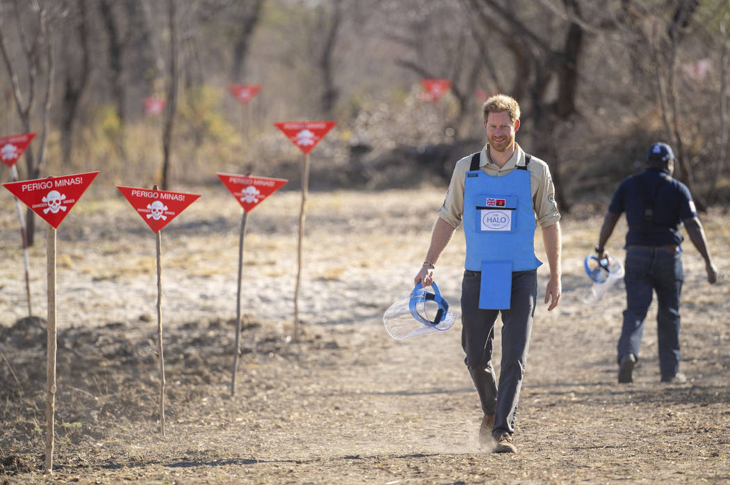 Britain's Prince Harry walks through a minefield in Dirico, Angola Friday Sept. 27, 2019, durin ...