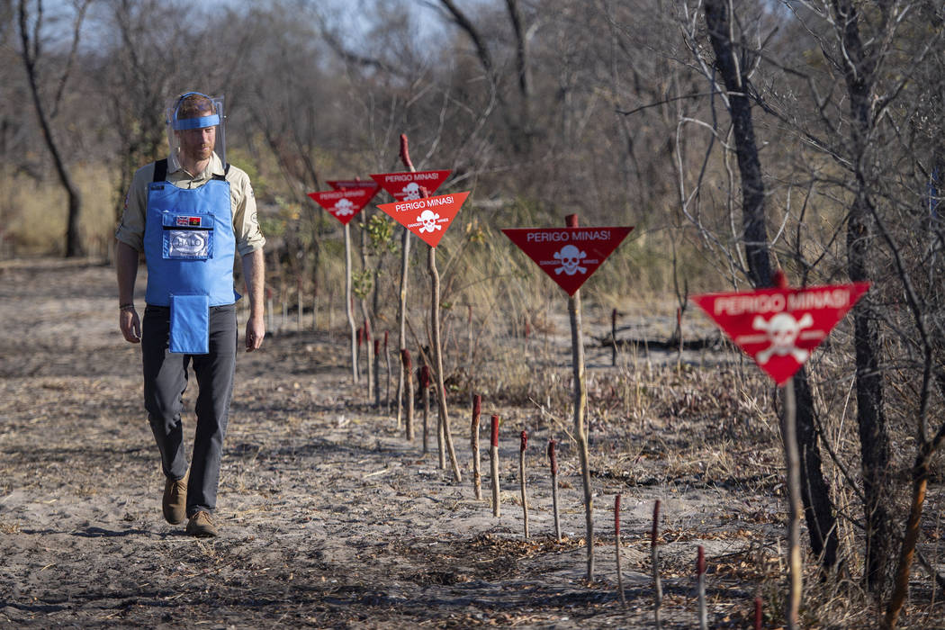 Britain's Prince Harry walks through a minefield in Dirico, Angola, Friday Sept. 27, 2019, duri ...