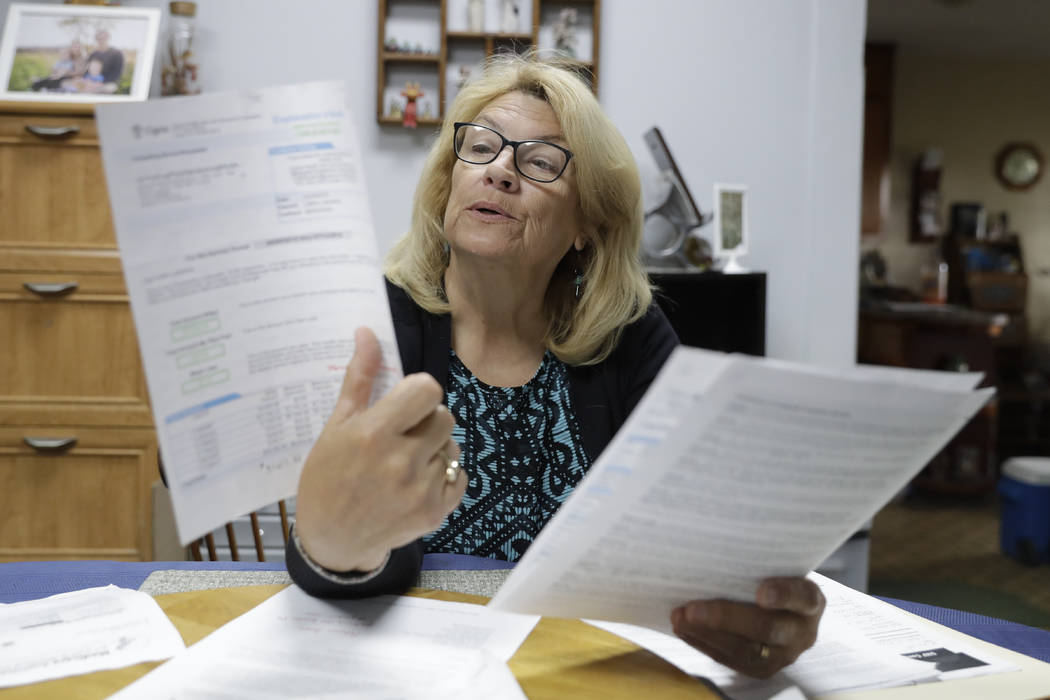 Linda Morris looks over her Medicare statements, Wednesday, Sept. 25, 2019, in Parker City, Ind ...