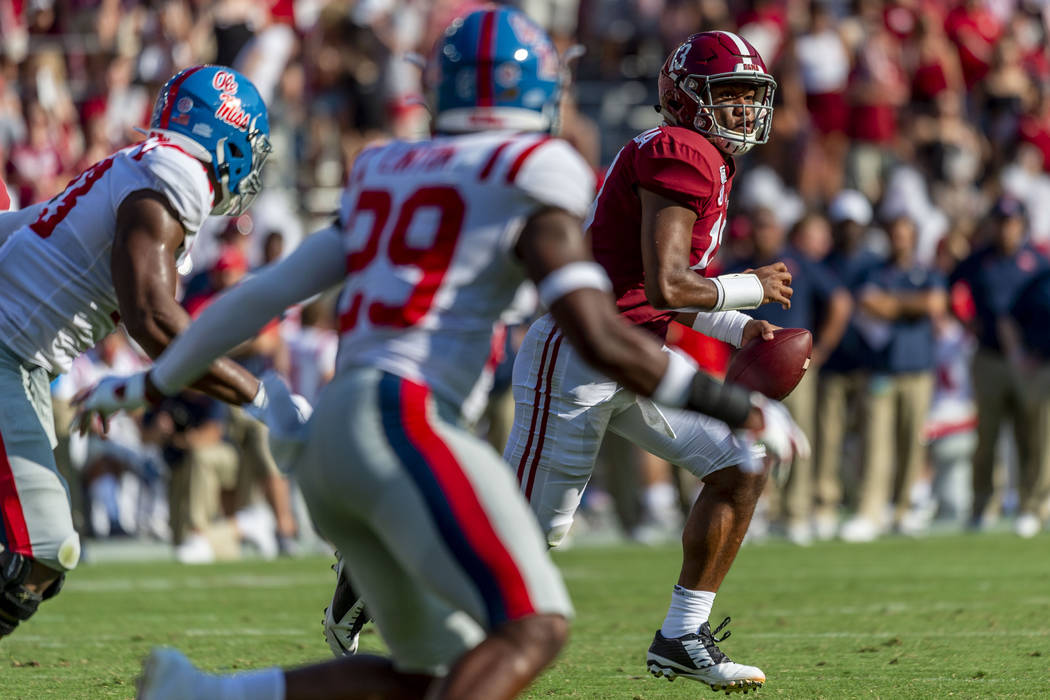 Alabama quarterback Tua Tagovailoa (13) rolls out against Mississippi during the first half of ...