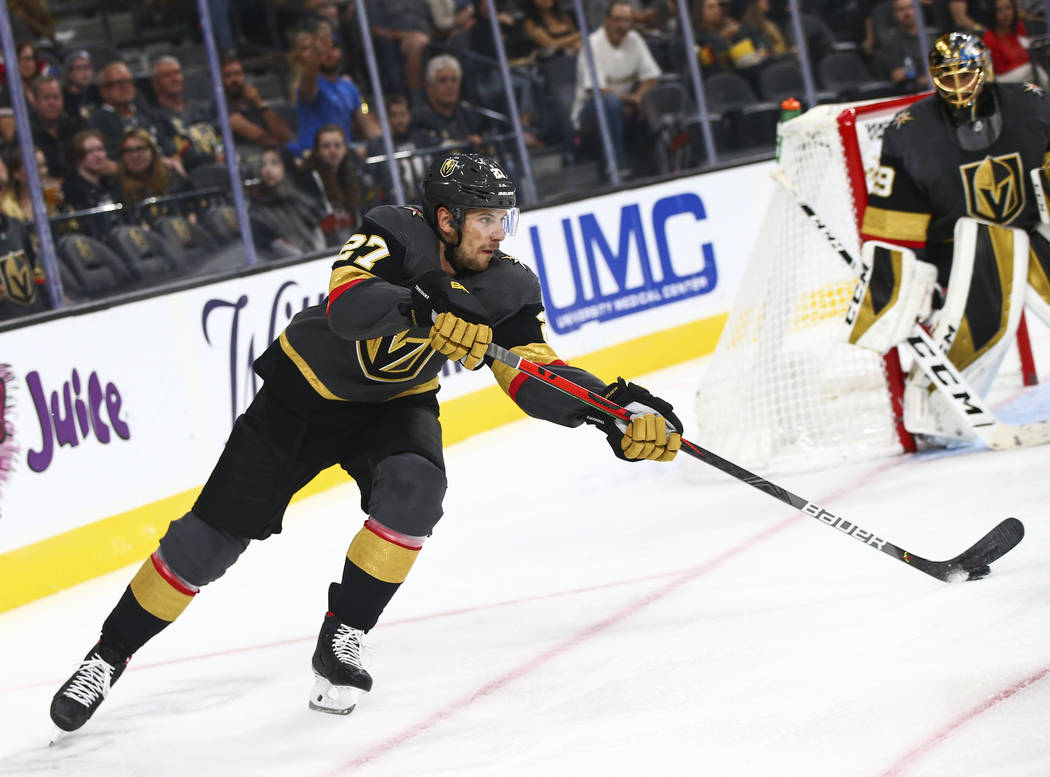 Golden Knights' Shea Theodore (27) moves the puck against the Los Angeles Kings during the seco ...