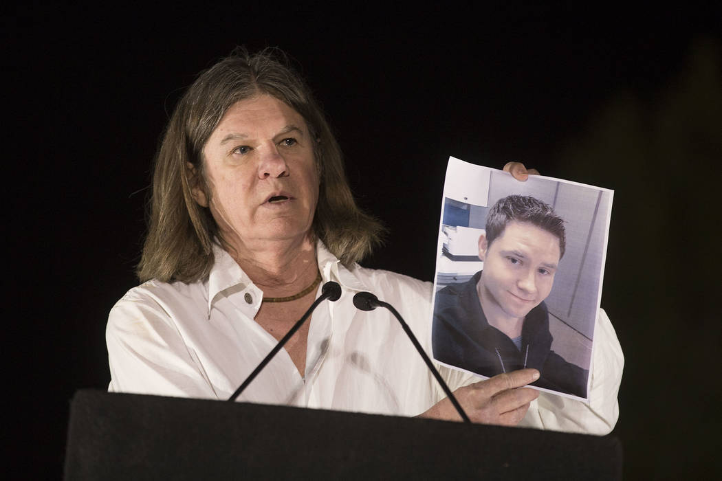 Las Vegas City Attorney Brad Jerbic holds up a sign of city employee and shooting victim Camero ...