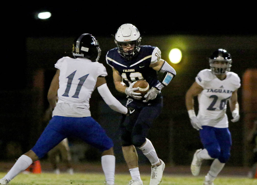 Desert Pines High's wide receiver Jett Solomon (11) defends Foothill High's wide receiver Thoma ...