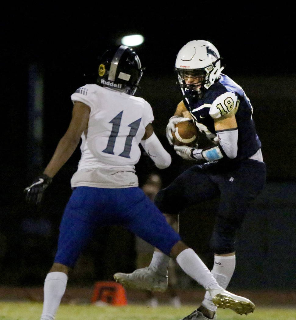 Desert Pines High's wide receiver Jett Solomon (11) defends Foothill High's wide receiver Thoma ...