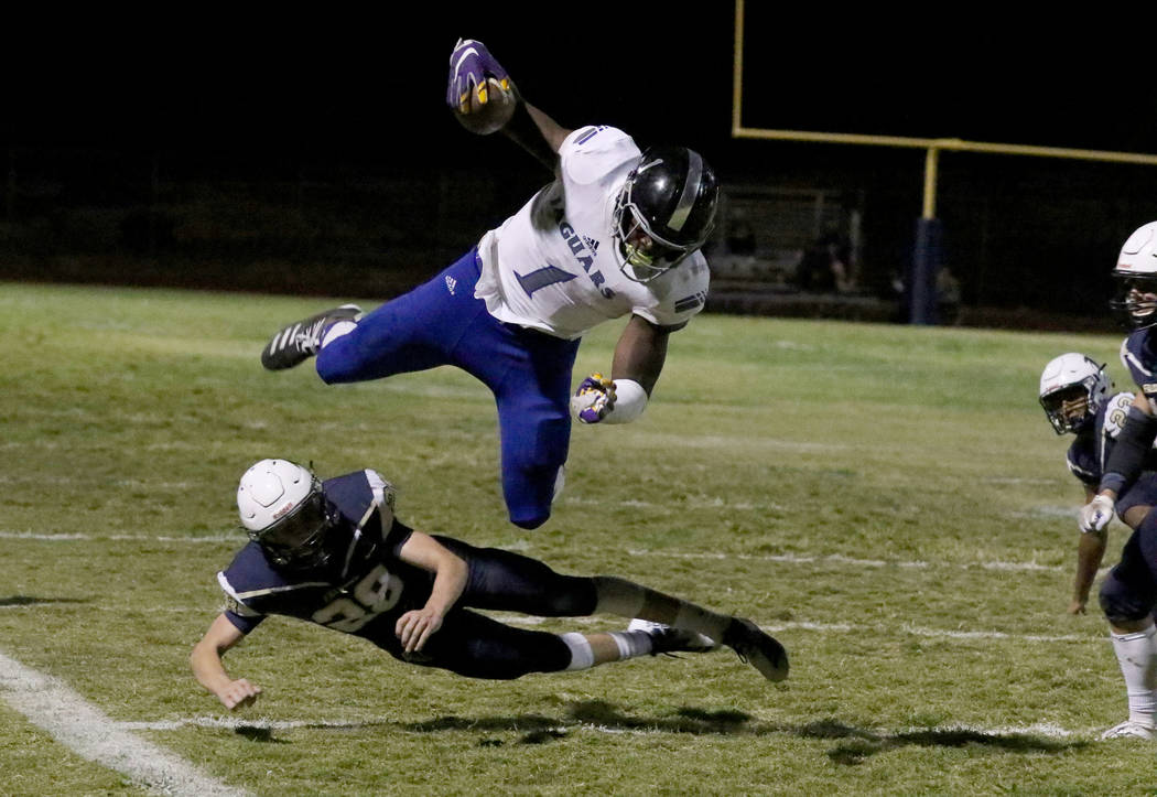 Desert Pines High's wide receiver Darnell Washington (1) avoids a tackle from Foothill High's&# ...