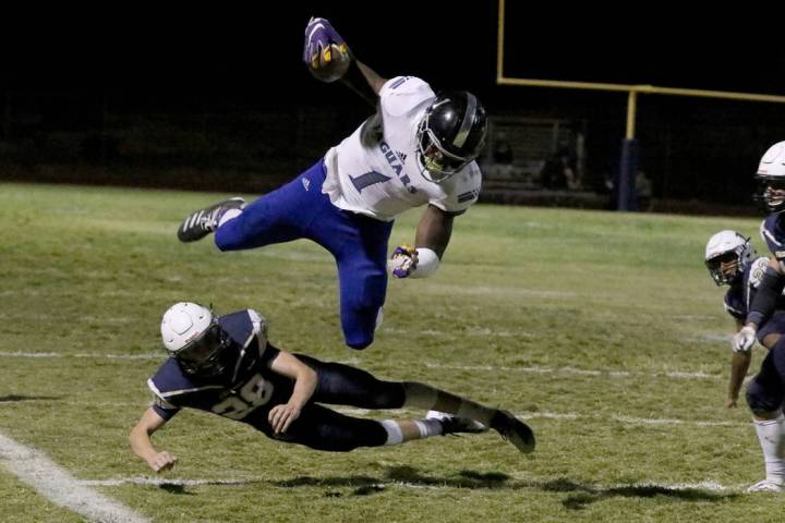 Desert Pines High's wide receiver Darnell Washington (1) avoids a tackle from Foothill High's&# ...