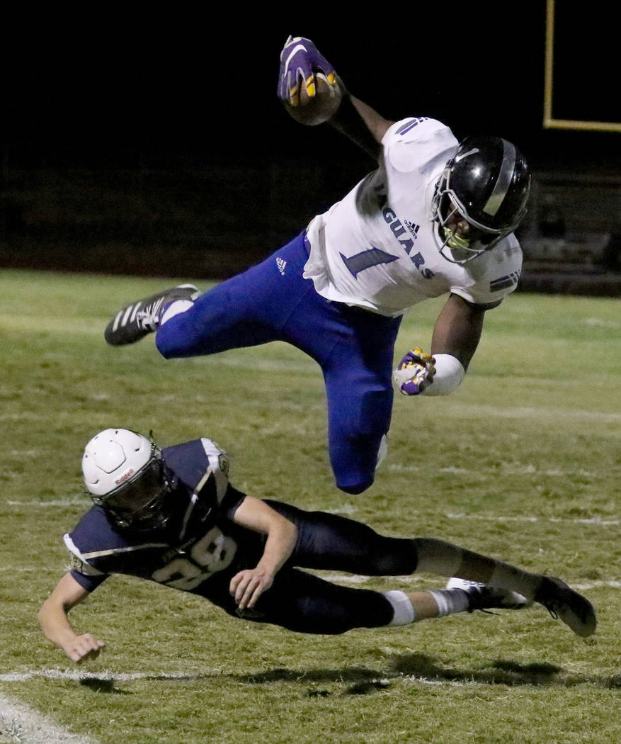 Desert Pines High's wide receiver Darnell Washington (1) avoids a tackle from Foothill High's&# ...