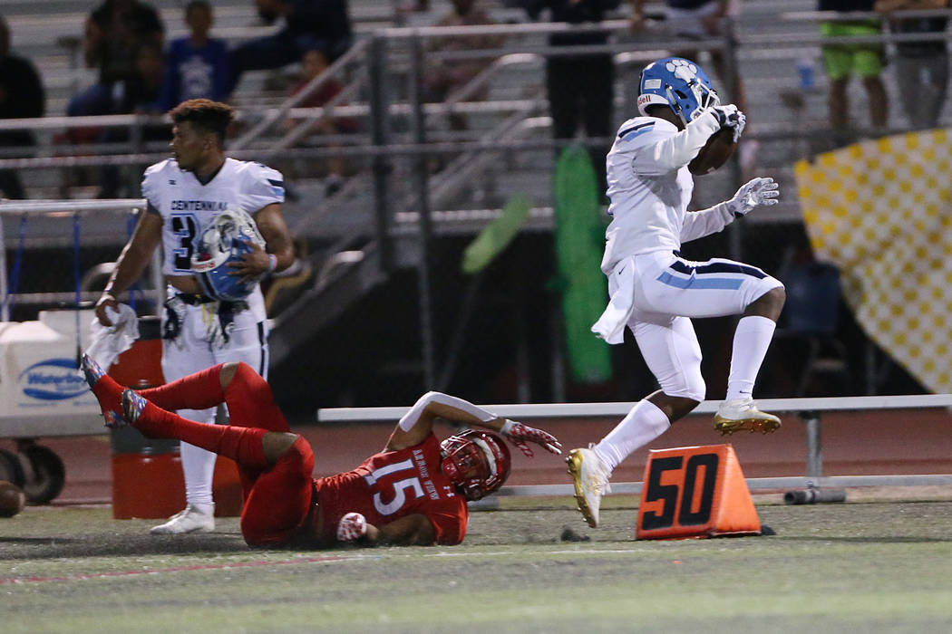 Centennial's Jordan Smith (1) runs the ball after a catch against Arbor View's Anthony Jones (1 ...