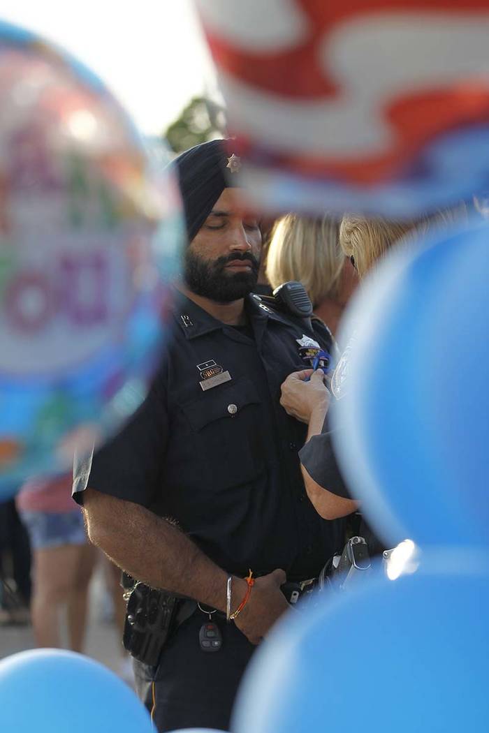 In this Aug. 29, 2015, photo, Harris County Sheriffs deputy Sandeep Dhaliwal gets a blue ribbon ...