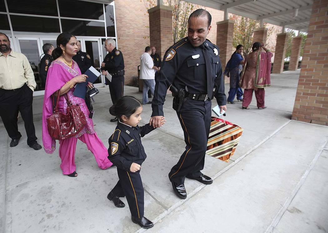 This Jan. 15, 2011, file photo shows Harwinder Dhaliwal walking behind daughter Japdeep Dhaliwa ...