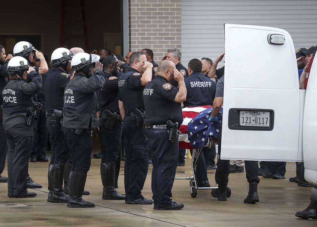 Law enforcement officers escort the body of Deputy Sandeep Dhaliwal, who was shot and killed af ...