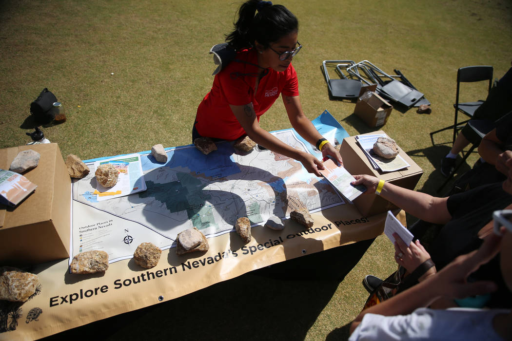 Trina Franco, volunteer coordinator for Get Outdoors Nevada, hands out maps during a celebratio ...