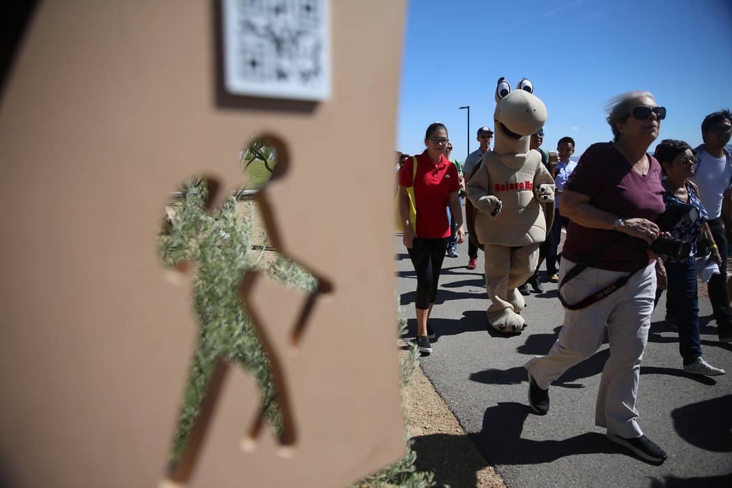 People participate in a nature walk during a celebration of the 3rd annual Public Lands Day at ...