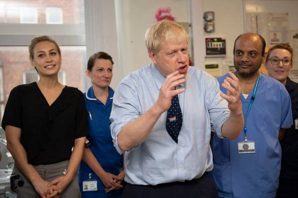 Britain's Prime Minister Boris Johnson speaks during a visit to North Manchester General Hospit ...