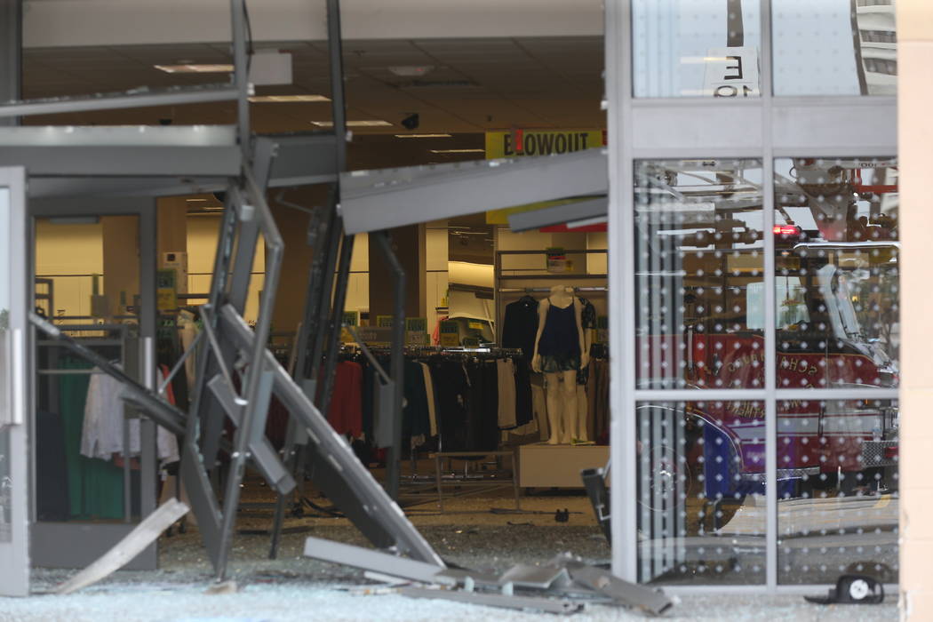 The damaged storefront of the Sears store at Woodfield Mall is seen after a man drove an SUV in ...