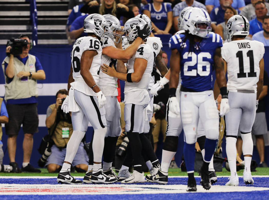 Oakland Raiders quarterback Derek Carr (4) celebrates his touchdown pass to tight end Foster Mo ...