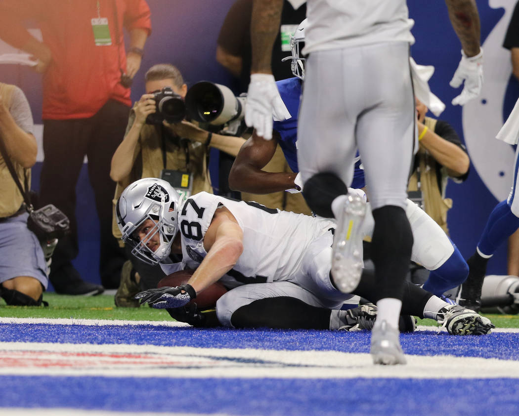 Oakland Raiders tight end Foster Moreau (87) scores a touchdown eduring the first half of an NF ...