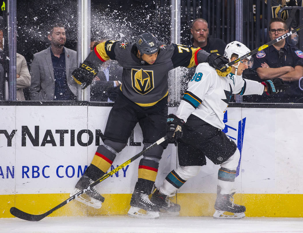 Vegas Golden Knights right wing Ryan Reaves (75) checks the boards with San Jose Sharks defense ...