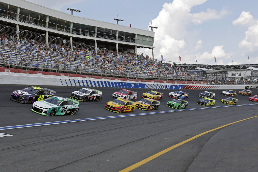 William Byron (24) and Jimmie Johnson (48) lead the field of cars through Turn 4 to start a NAS ...