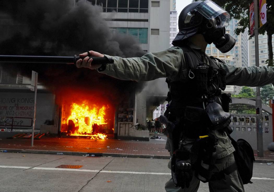 Riot police arrive after protestors vandalize in Hong Kong, Sunday, Sept. 29, 2019. Riot police ...