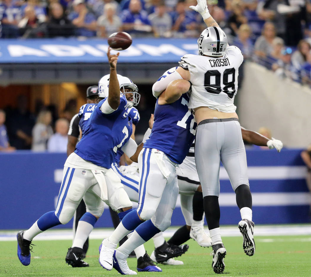 Oakland Raiders defensive end Maxx Crosby (98) jumps to deflect a football thrown by Indianapol ...