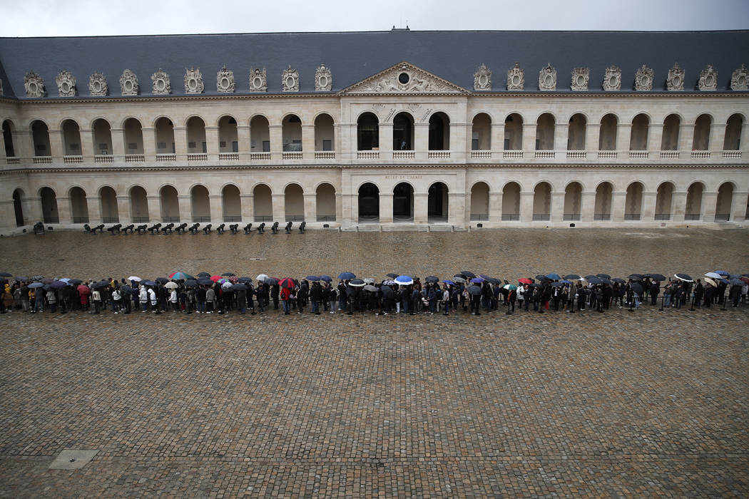 People queue at the Invalides monument to pay their respects to late French President Jacques C ...