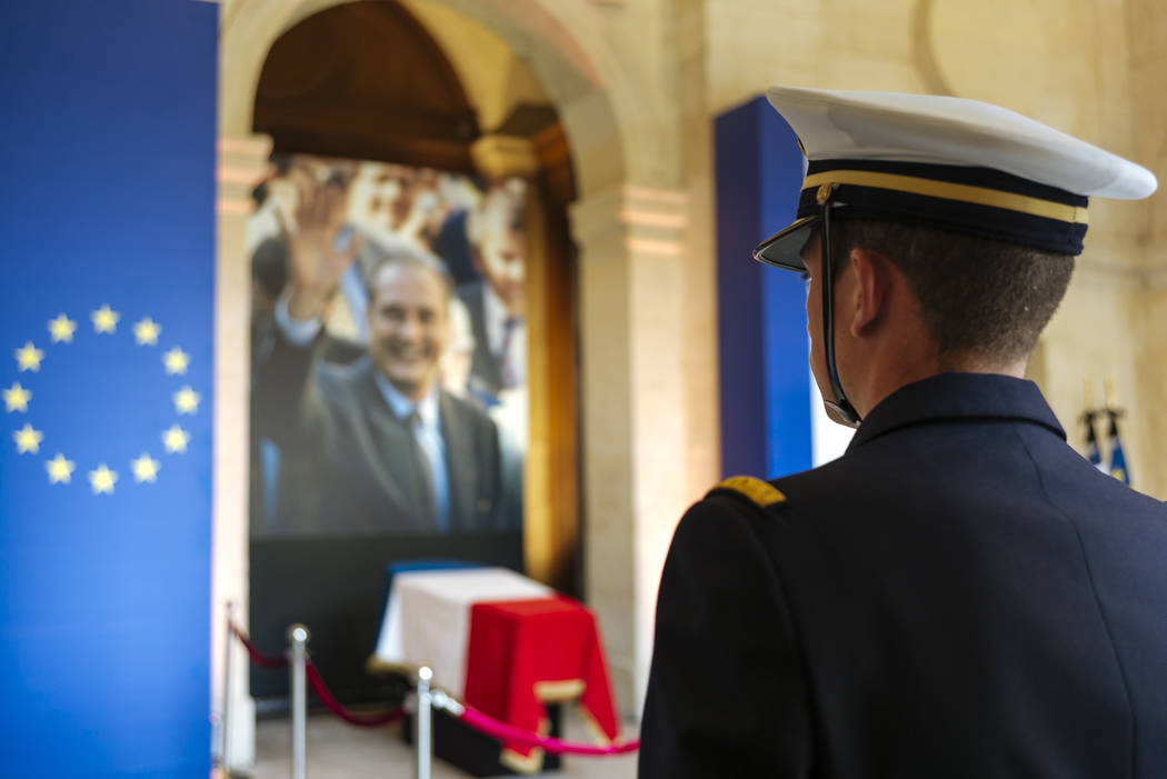 A military officer stands guard in front of the coffin of late French President Jacques Chirac, ...