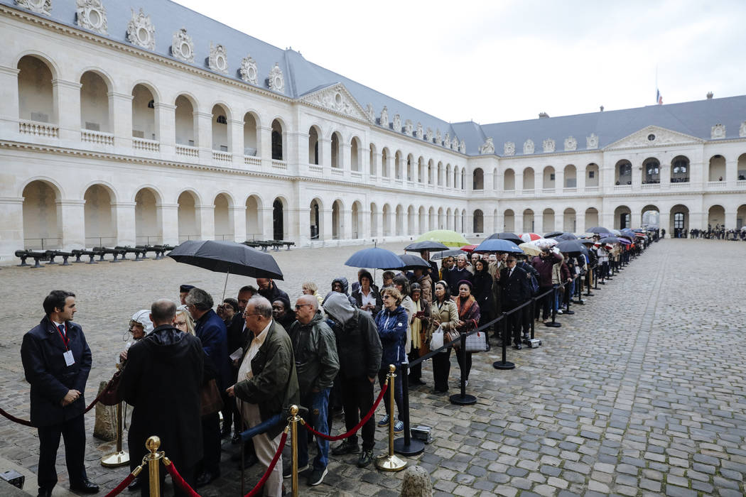 Visitors queue to pay their respects to former French President Jacques Chirac, Sunday, Sept. 2 ...