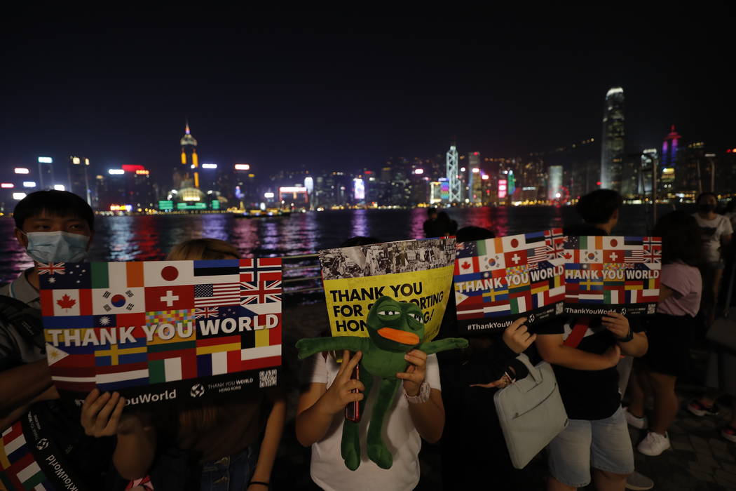 People form a human chain in support of protest movement in the harbor area in Hong Kong, Mond ...