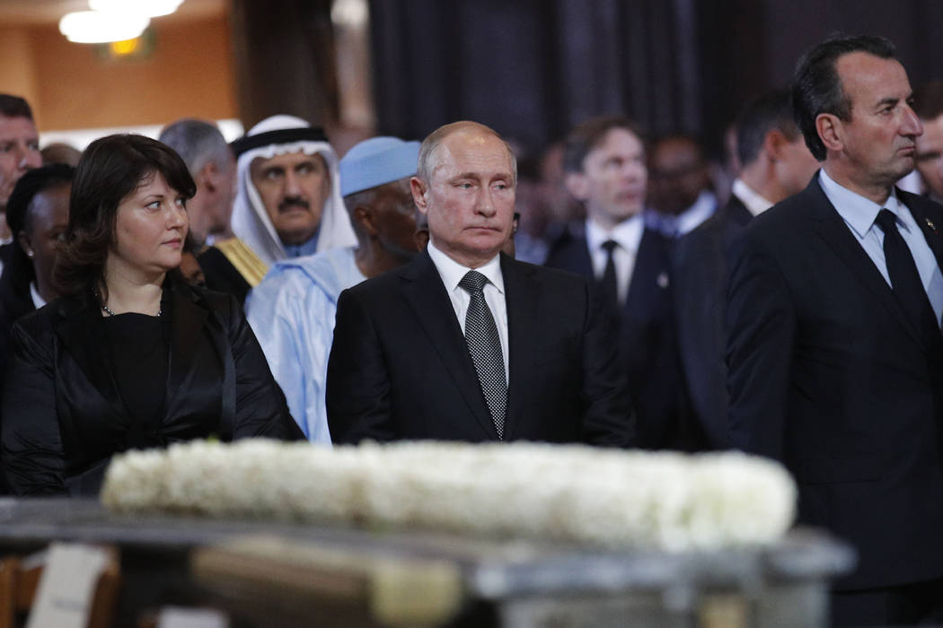 Russian President Vladimir Putin, center, stands before a service for late French President Jac ...