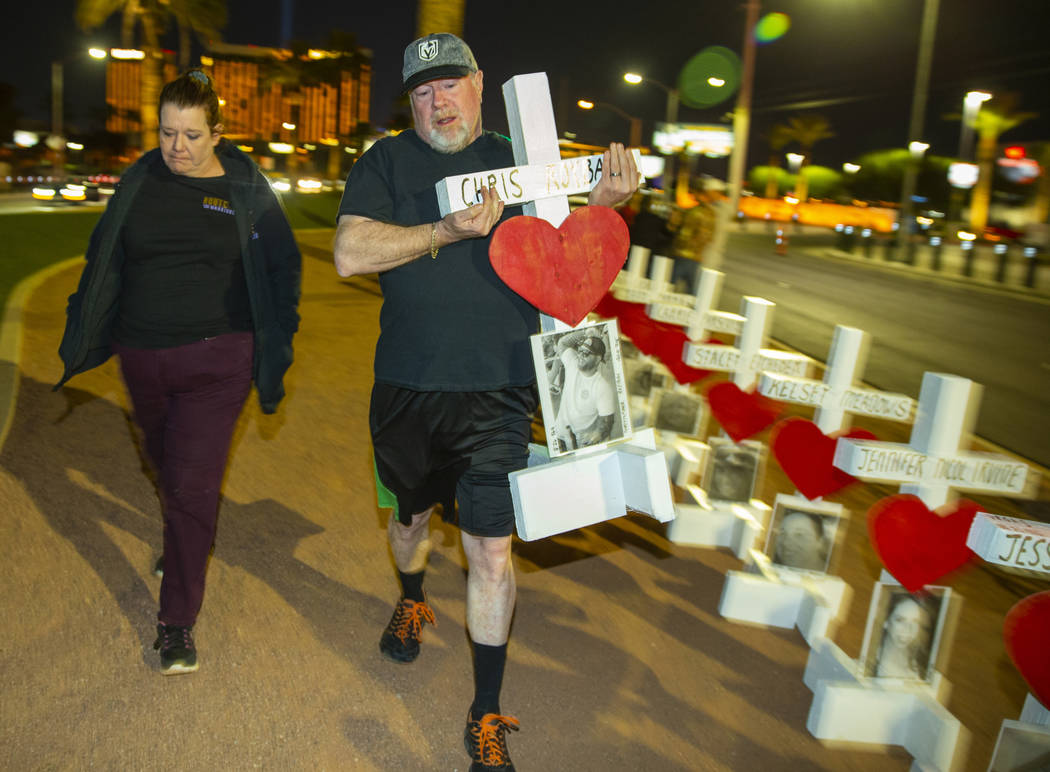 Michael and Leah Tuckman carry away a cross for Chris Roybal which they will present to his mot ...