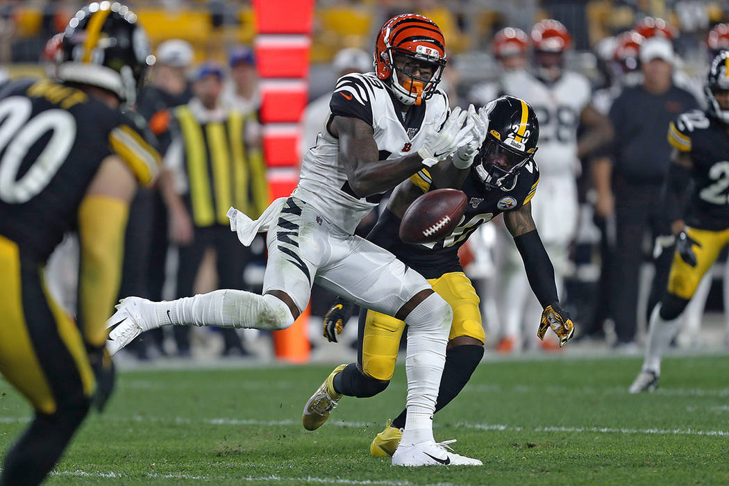 Cincinnati Bengals wide receiver Auden Tate (19) can't hang onto a pass from quarterback Andy D ...