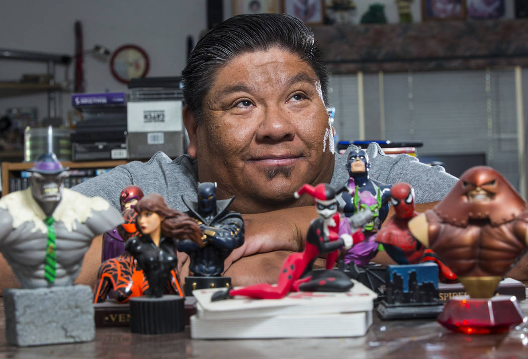 Theo Tso, creator of Captain Paiute, poses with superhero figurines at his home in Las Vegas on ...