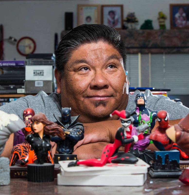 Theo Tso, creator of Captain Paiute, poses with superhero figurines at his home in Las Vegas on ...