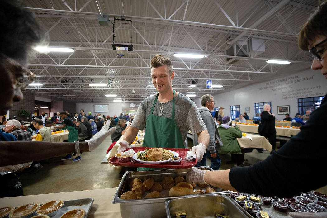 Musician Nick Carter, a member of the Backstreet Boys, loads up his tray with a Thanksgiving me ...