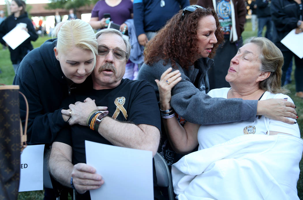 Adriane Geggie, left, of Irvine, Calif., hugs Steve Darling as Michelle Eisenberg of Chino Hill ...