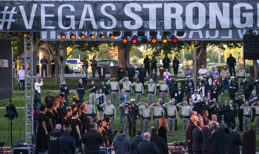 Law enforcement officers salute as a multi-agency honor guard presents the colors during a sunr ...