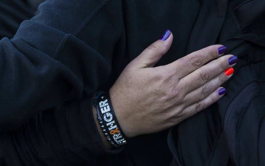 Route 91 Harvest festival shooting survivor Connie Long of Riverside, Calif., embraces a friend ...