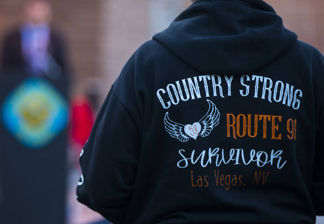 A Route 91 Harvest festival survivor listens during a sunrise ceremony at the Clark County Gove ...