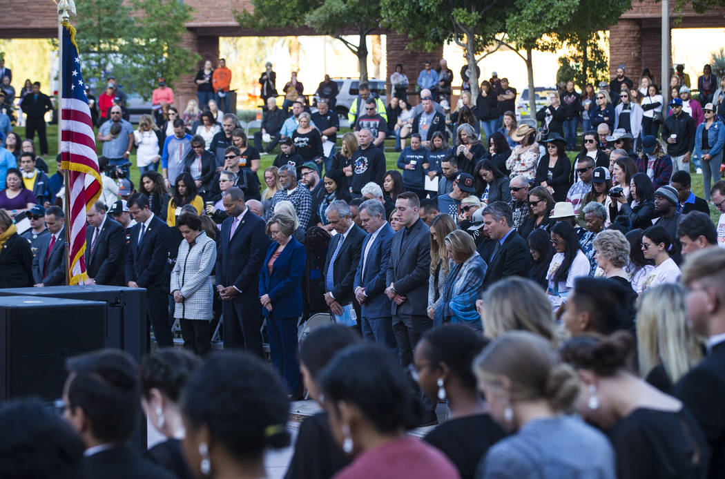 Attendees observe a moment of silence during a sunrise ceremony at the Clark County Government ...