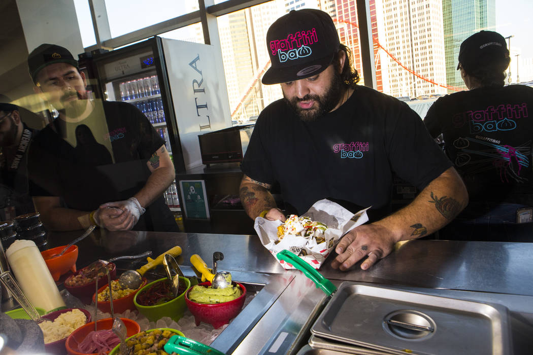 Graffiti Bao and Pina Nachos owner and chef Marc Marrone prepares nachos before the start of a ...