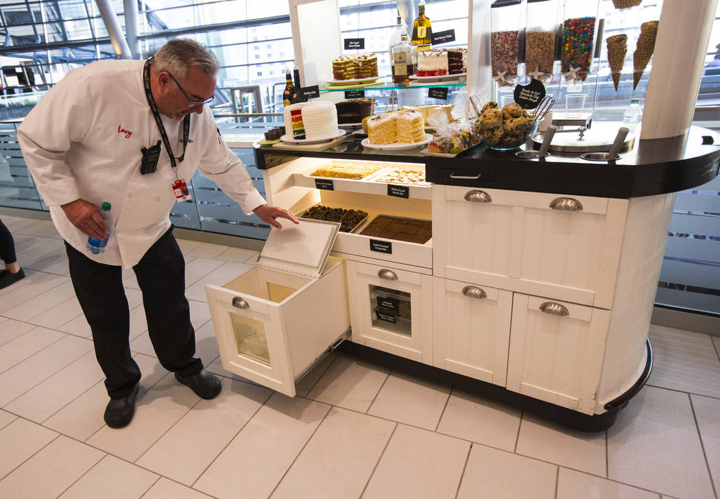 Rick Giffen, executive chef with Levy, shows off the milk bottles available for cookies and oth ...