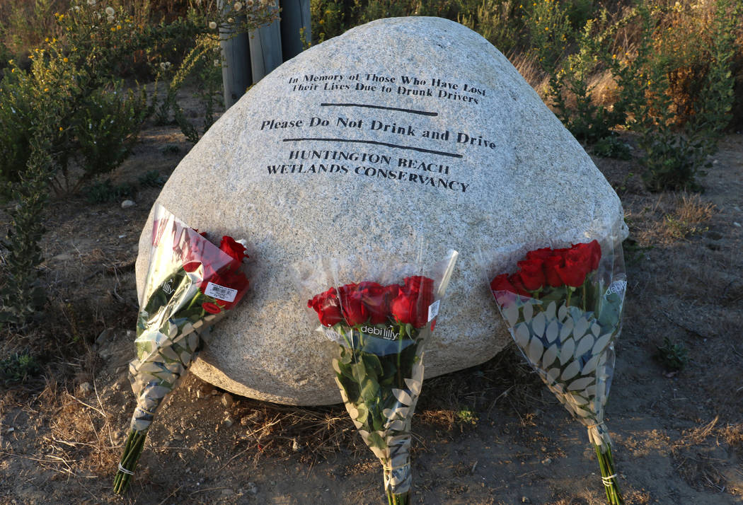 Three bouquet of roses, one for each of teens killed in a fiery crash last year in Huntington B ...