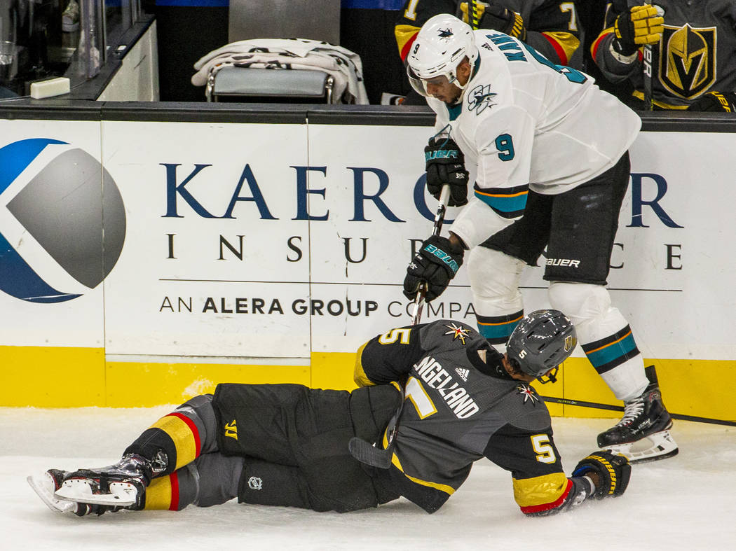 San Jose Sharks left wing Evander Kane (9, top) trips up Vegas Golden Knights defenseman Deryk ...