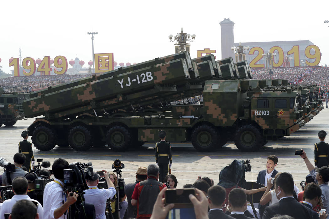 Military vehicles roll down during a parade to commemorate the 70th anniversary of the founding ...