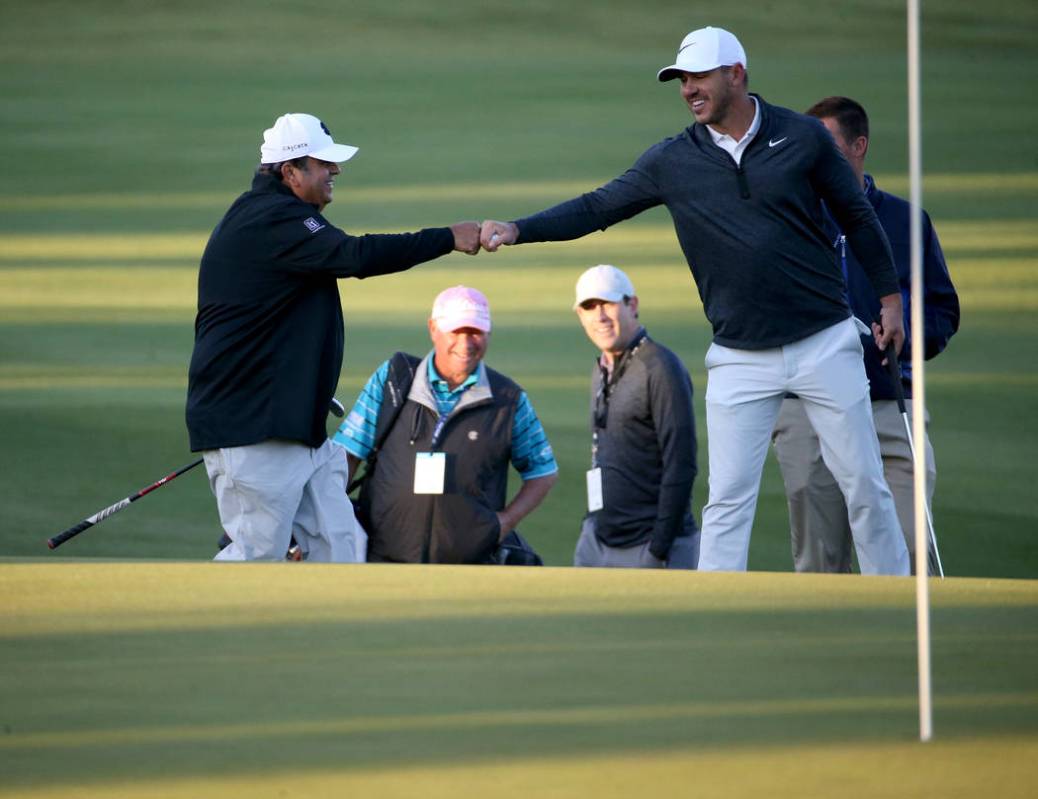 Brooks Koepka, right, fist-pumps partner Ali Saleh of Cincinnati after Saleh chipped in for par ...