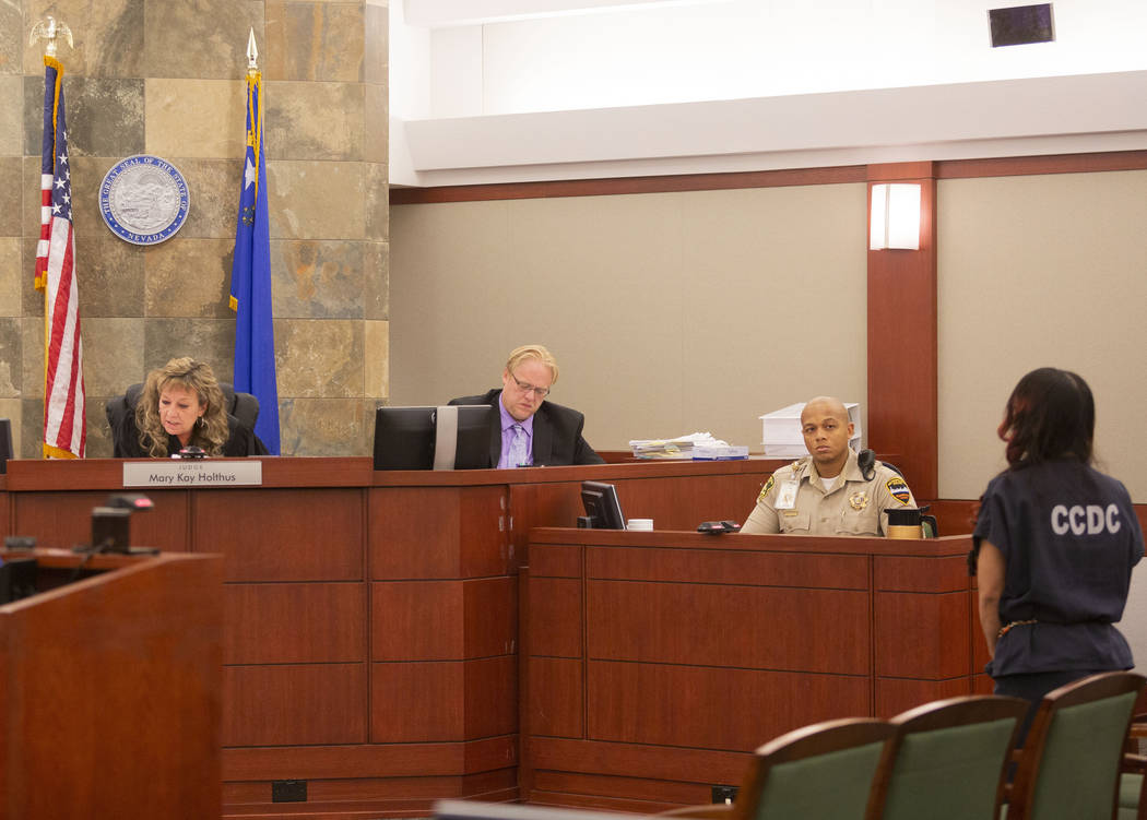 Gigi Mitchell, right, accused of trafficking an 11-year-old girl, stands in front of Judge Mary ...