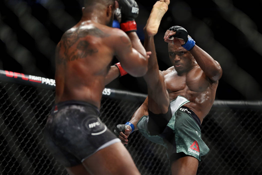 Kamaru Usman kicks Tyron Woodley in the welterweight title bout during UFC 235 at T-Mobile Aren ...